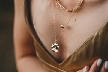 woman-in-gold-sleeveless-dress-wearing-gold-necklace.jpg woman in gold sleeveless dress wearing gold necklace